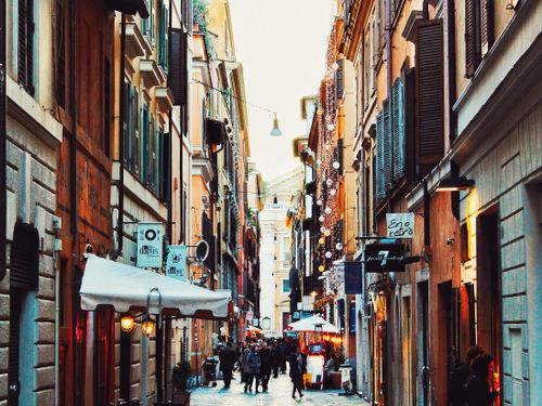 Free Vibrant European alley bustling with people and colorful architecture, ideal for tourism and travel visuals. Stock Photo
