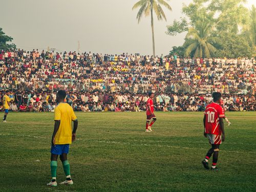 Free A lively soccer match in Mymensingh, Bangladesh, with a packed audience enjoying the game. Stock Photo
