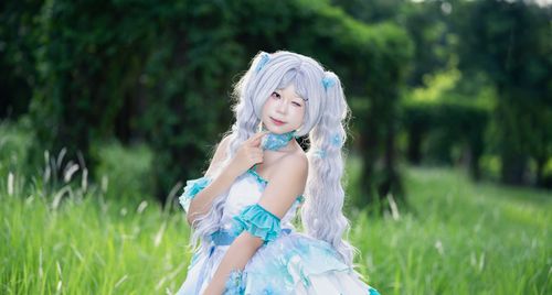 Free Cosplayer in a vibrant blue and white outfit posing outdoors in lush greenery. Stock Photo