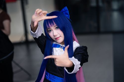 Free A woman in cosplay costume poses creatively indoors, depicting vibrant anime style. Stock Photo