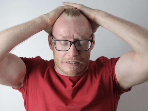 Free Upset male with headache taking break after intensive work Stock Photo