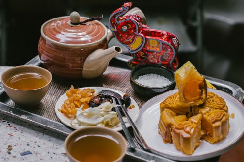 Free Elegant tea setting with mooncakes and snacks, perfect for festive celebrations. Stock Photo