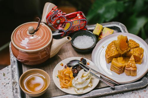Free Arrangement of Chinese teapot, mooncakes, and dried fruits on a tray, symbolizing cultural tea time. Stock Photo