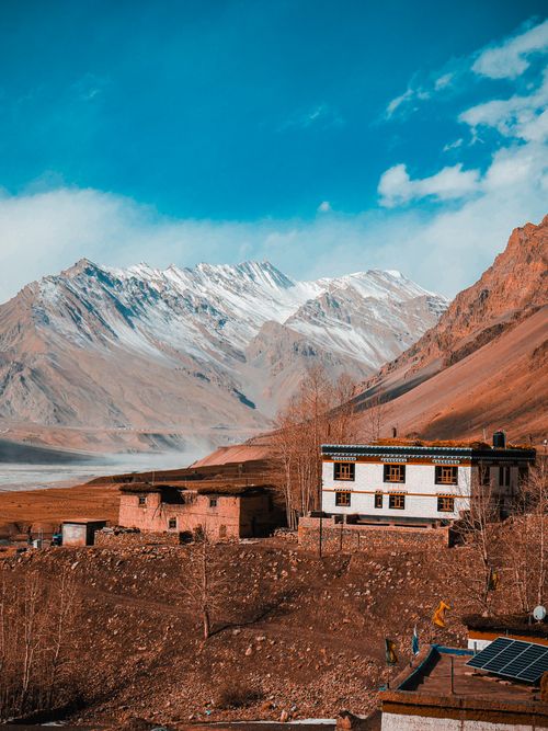 Free Scenic Himalayan landscape in Ladakh, India, featuring traditional village houses under a bright blue sky. Stock Photo