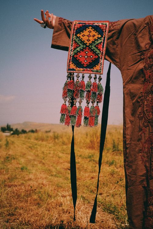 Free Close-up of a colorful traditional embroidered textile held outdoors in Tajikistan. Stock Photo