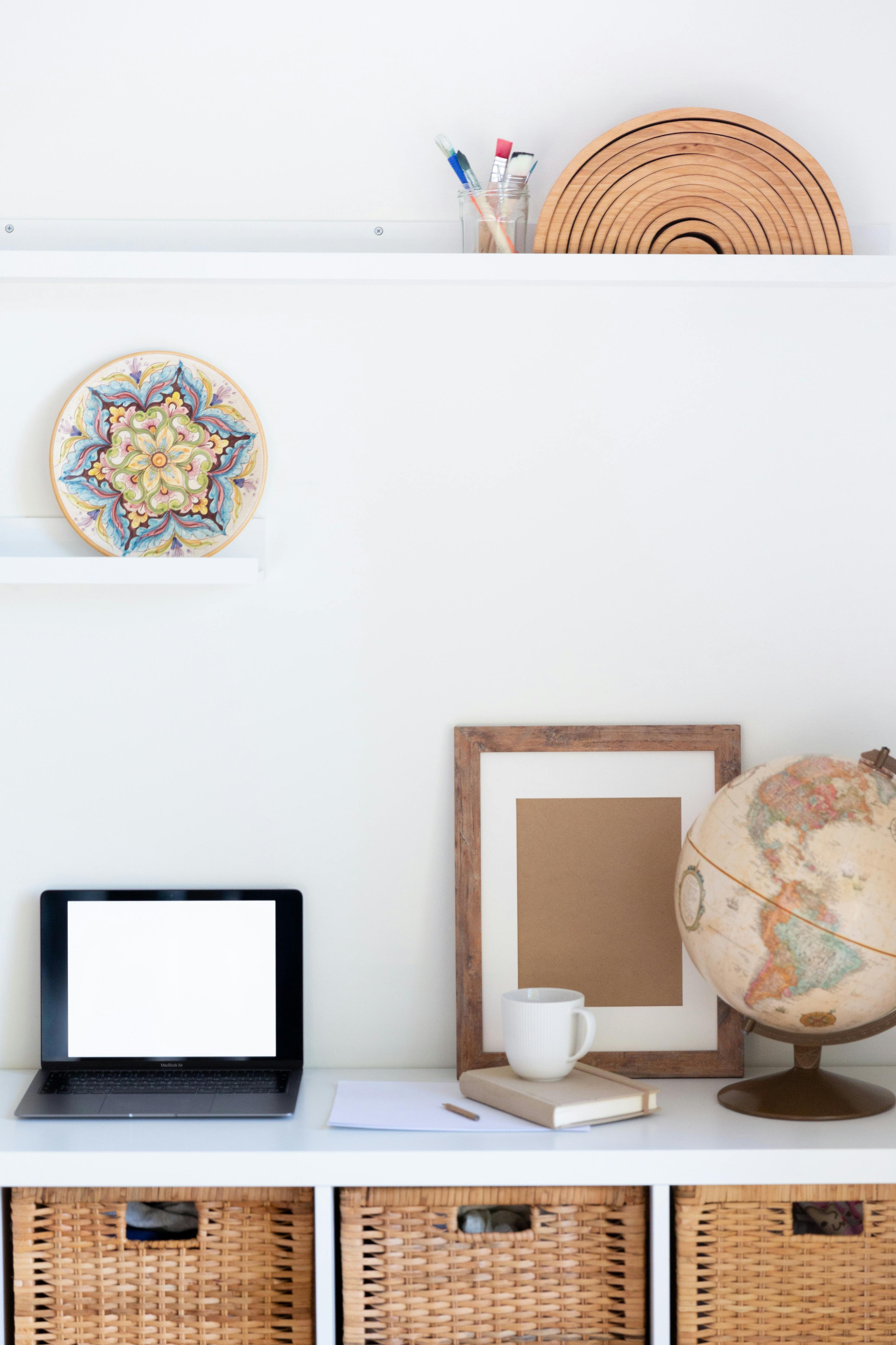 vintage furniture with empty frame and blank screen of netbook in light room