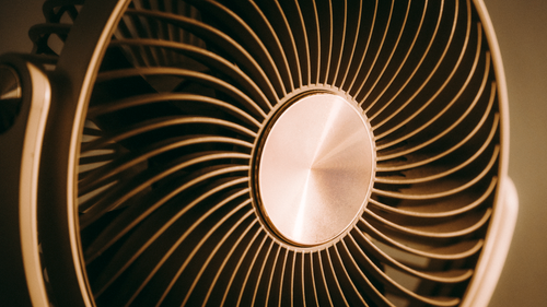 Free Abstract close-up view of a metal fan with radial blades in brown tones enhancing the texture. Stock Photo