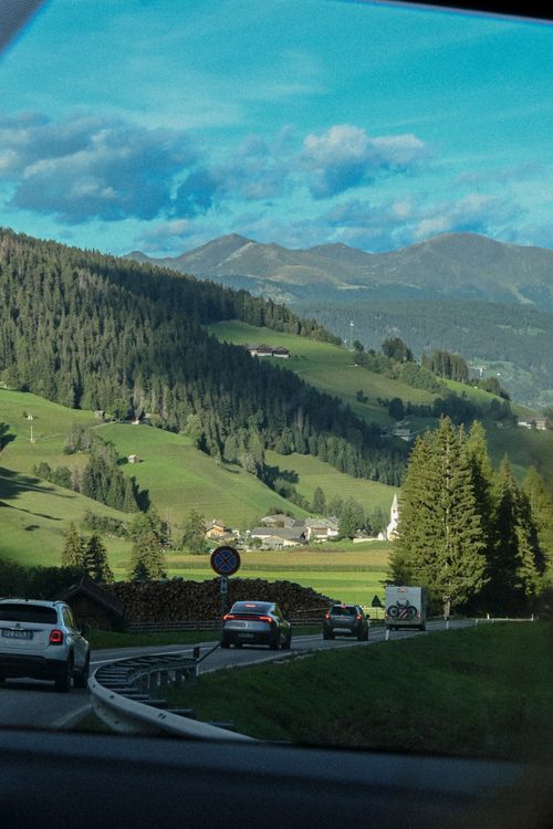 Free Charming valley road through alpine mountains with cars in scenic landscape views. Stock Photo