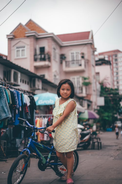 Little Girl Holding A Bike