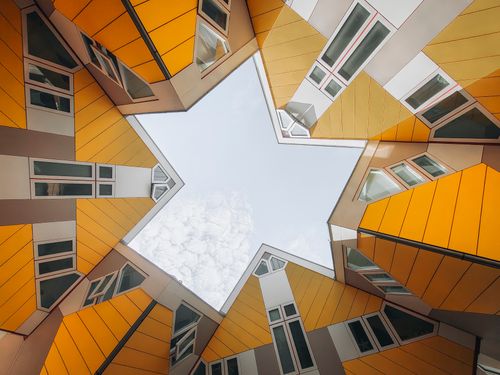 Free Dynamic architectural shot of Rotterdam's iconic Cube Houses, creating a star-shaped sky view. Stock Photo