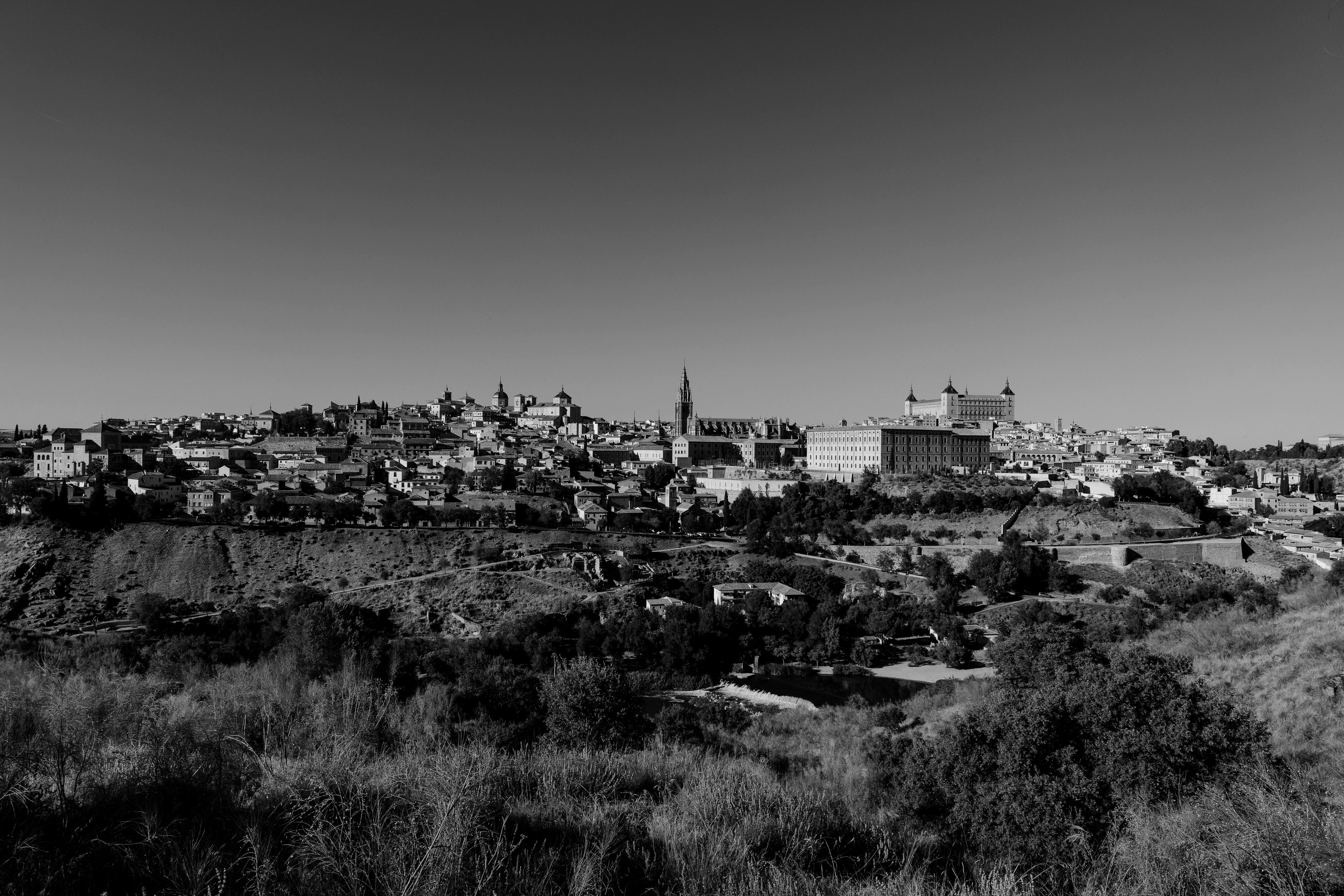 Captivating black and white view of Toledo's skyline showcasing historic architecture and landscape.