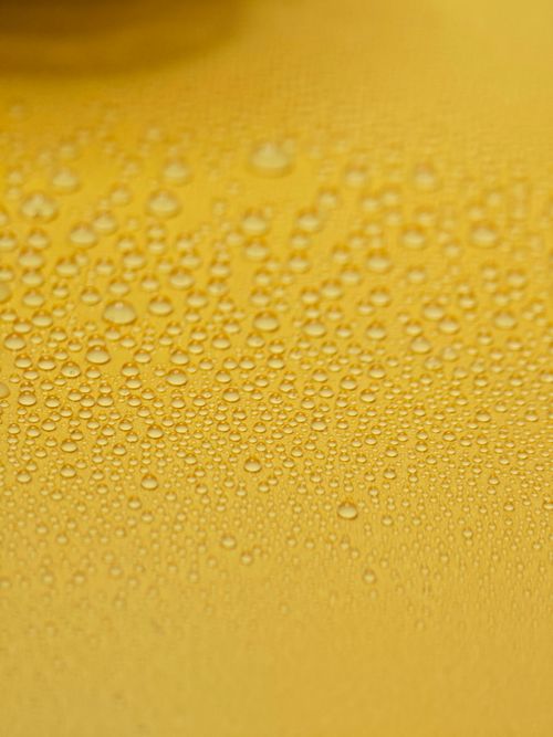 Free Abstract closeup of water droplets on a yellow surface, capturing texture and pattern. Stock Photo