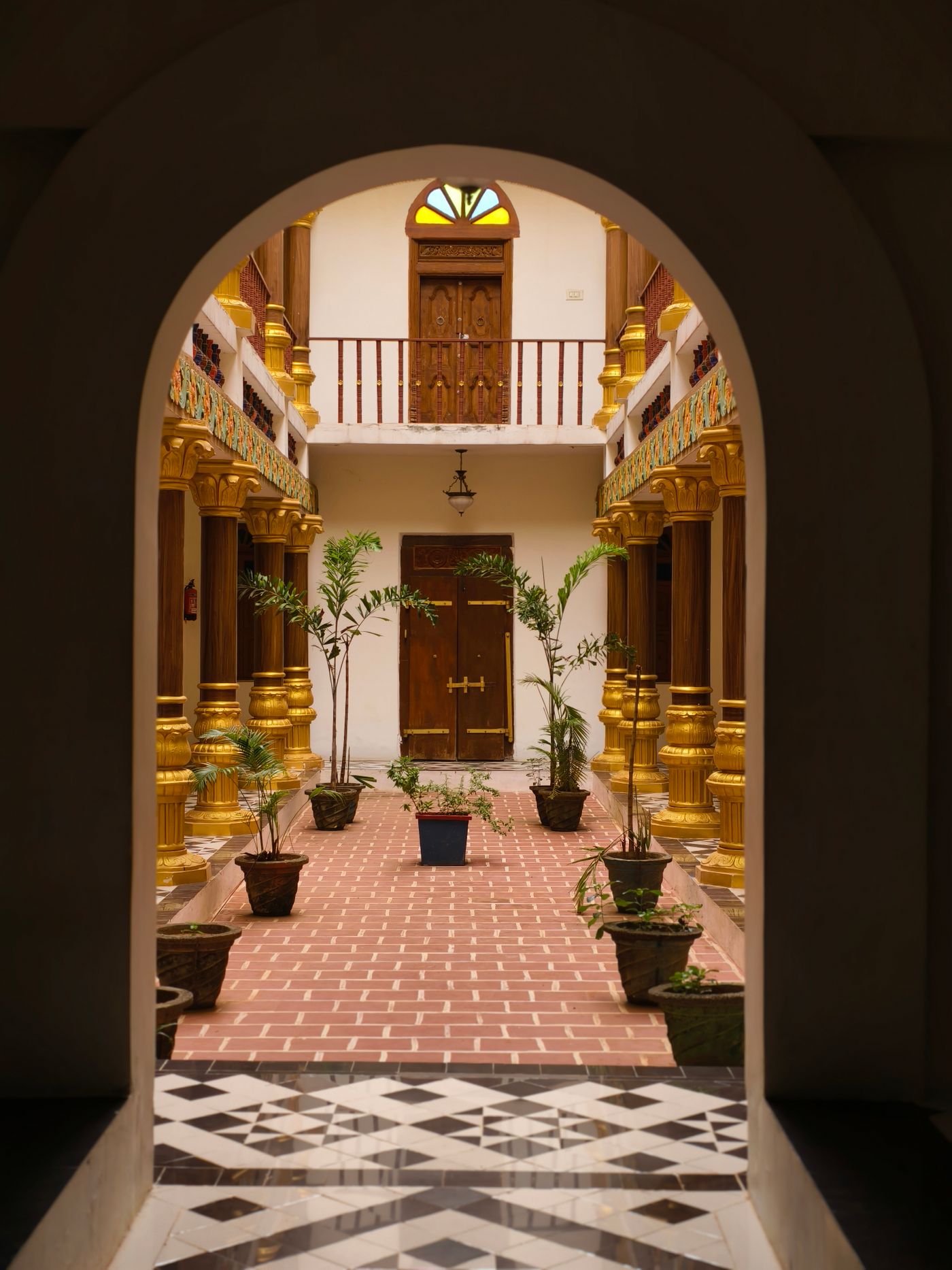 Arched passage opening onto an inner court with a patterned floor