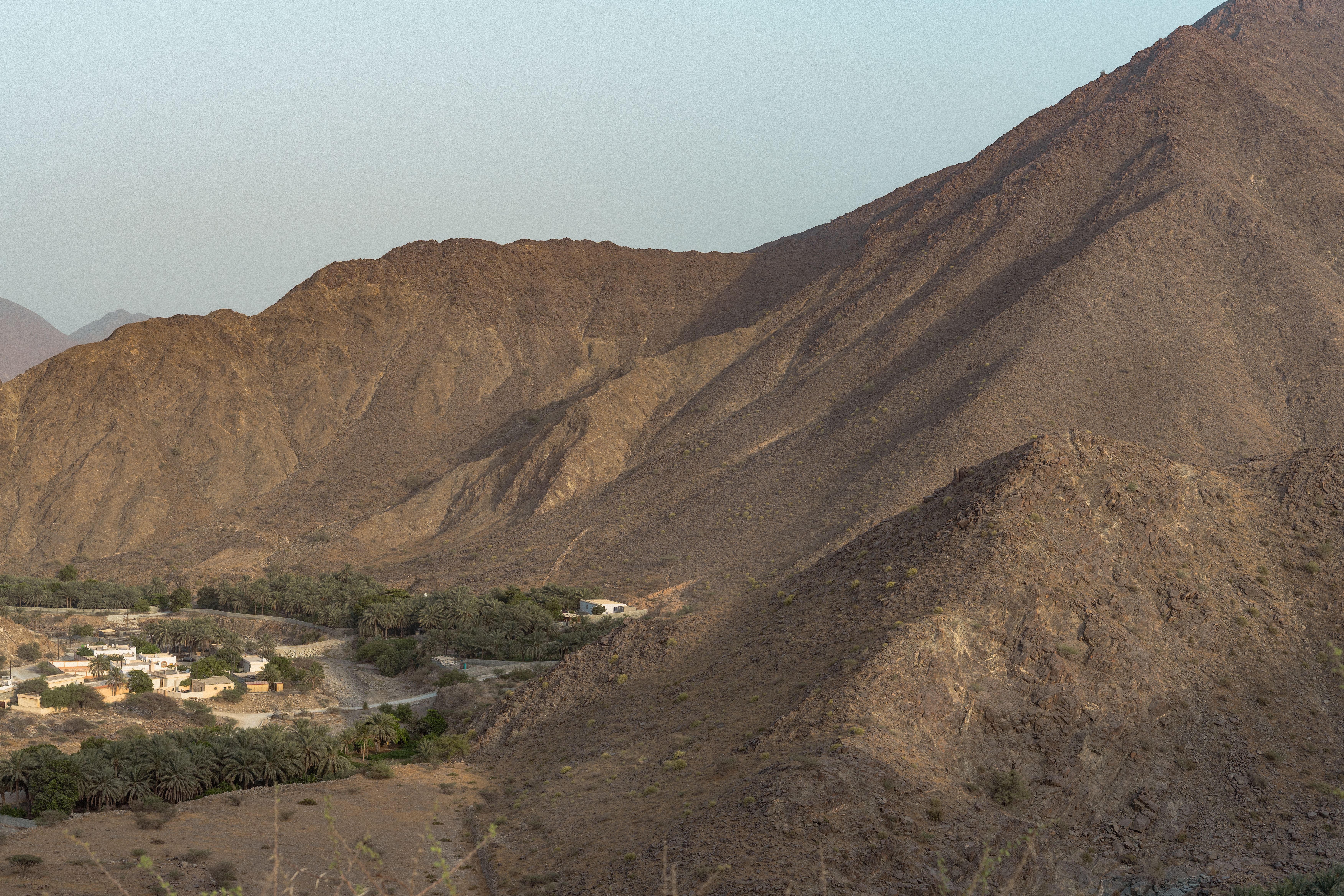 Breathtaking view of rugged mountains in Khor Fakkan, Sharjah, UAE, capturing natural beauty at dawn.