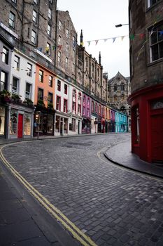 Charming view of Victoria Street with colorful buildings and cobblestones in Edinburgh, Scotland.