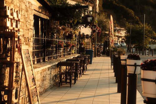 Free Atmospheric view of a cozy sidewalk cafe in Berat, Albania during sunset. Stock Photo