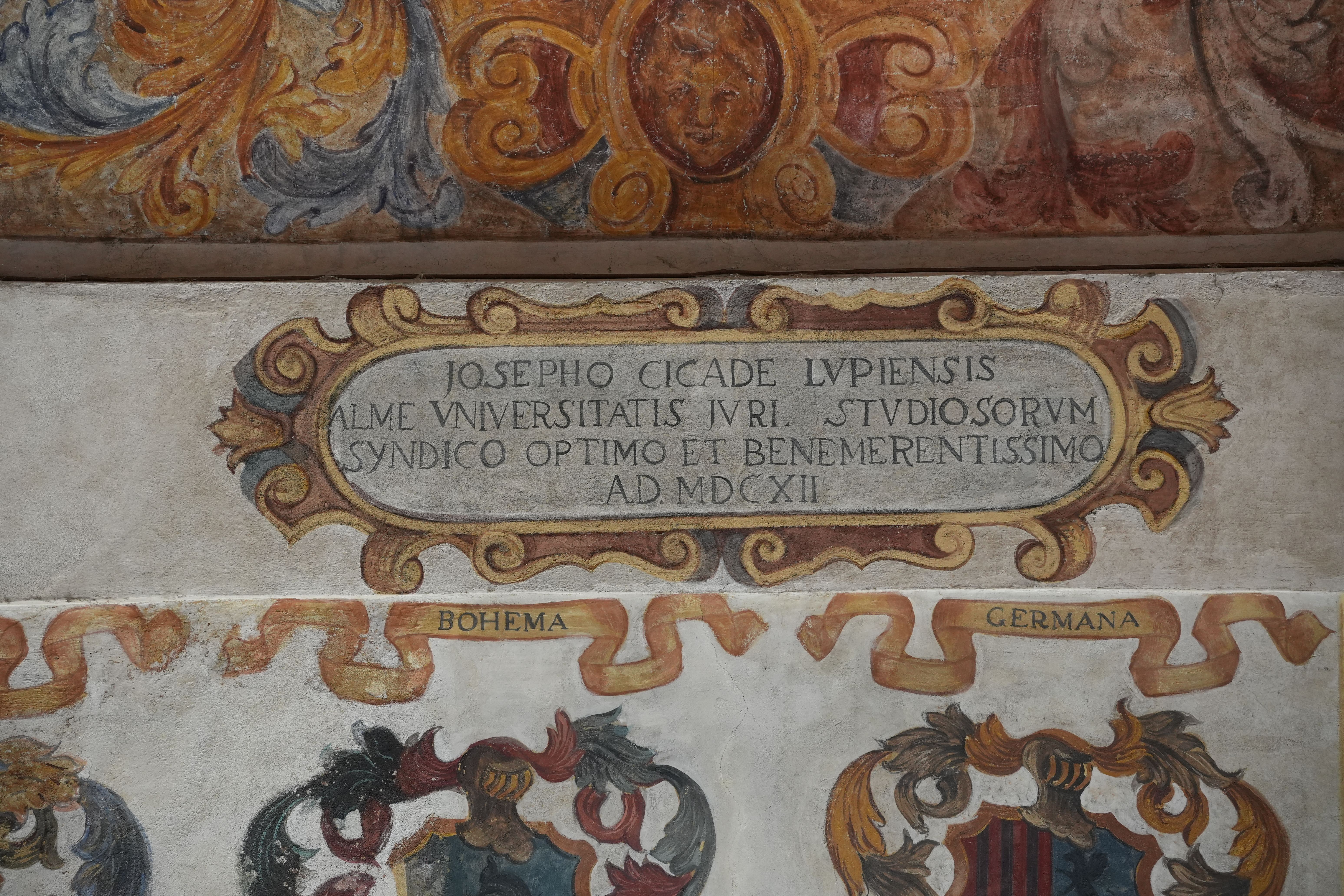 Ornate Latin fresco at the University of Padua, Italy, capturing historical academic heritage.