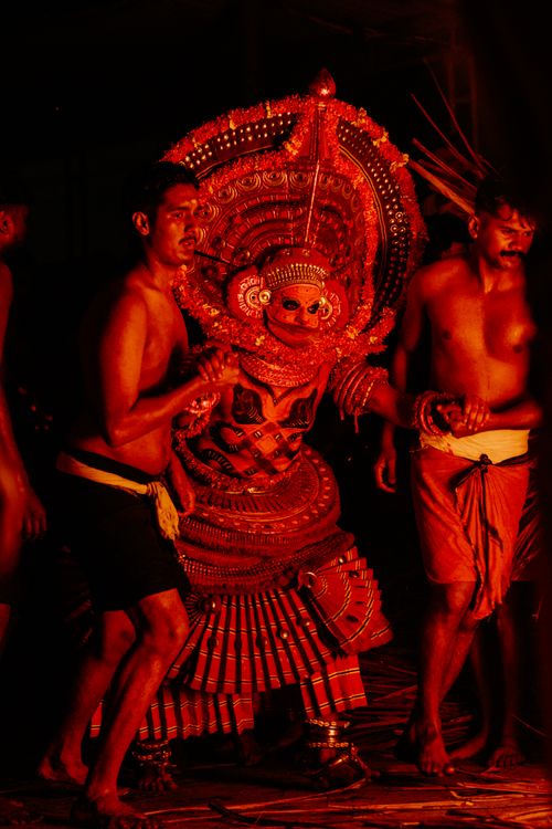 Free Captivating night display of traditional Theyyam dance in Kerala, rich with cultural heritage and vibrant costumes. Stock Photo