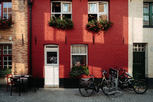 Bicycles Parked Beside Red Brick Building