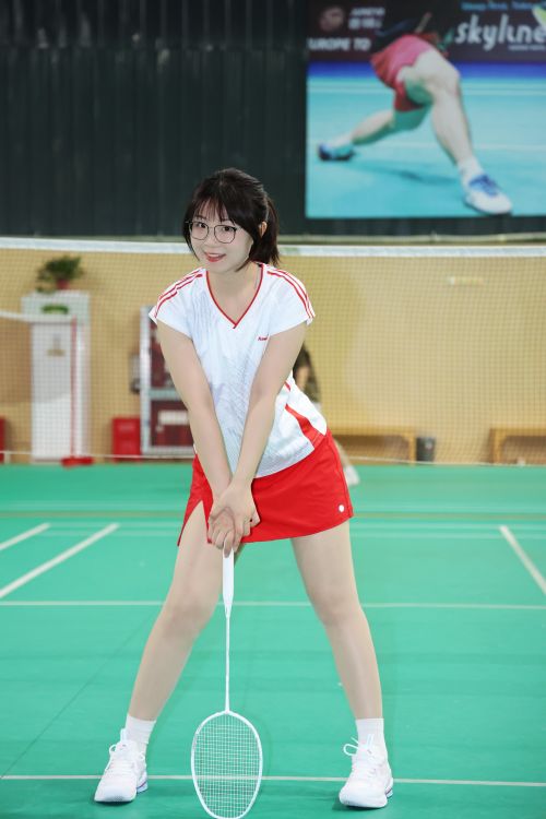 Free Athletic young woman in a badminton court ready to serve. Stock Photo
