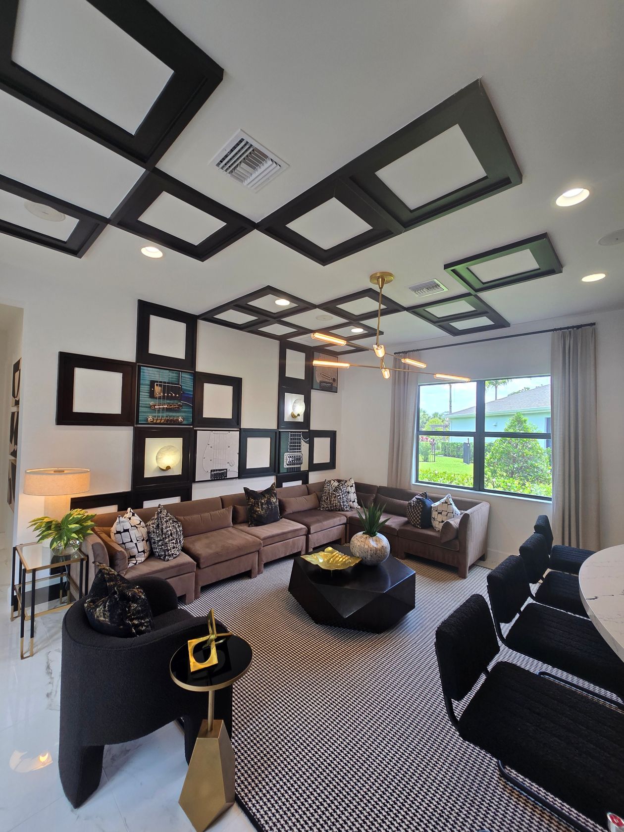 Living room corner with a geometric houndstooth rug and bold black-and-white pattern