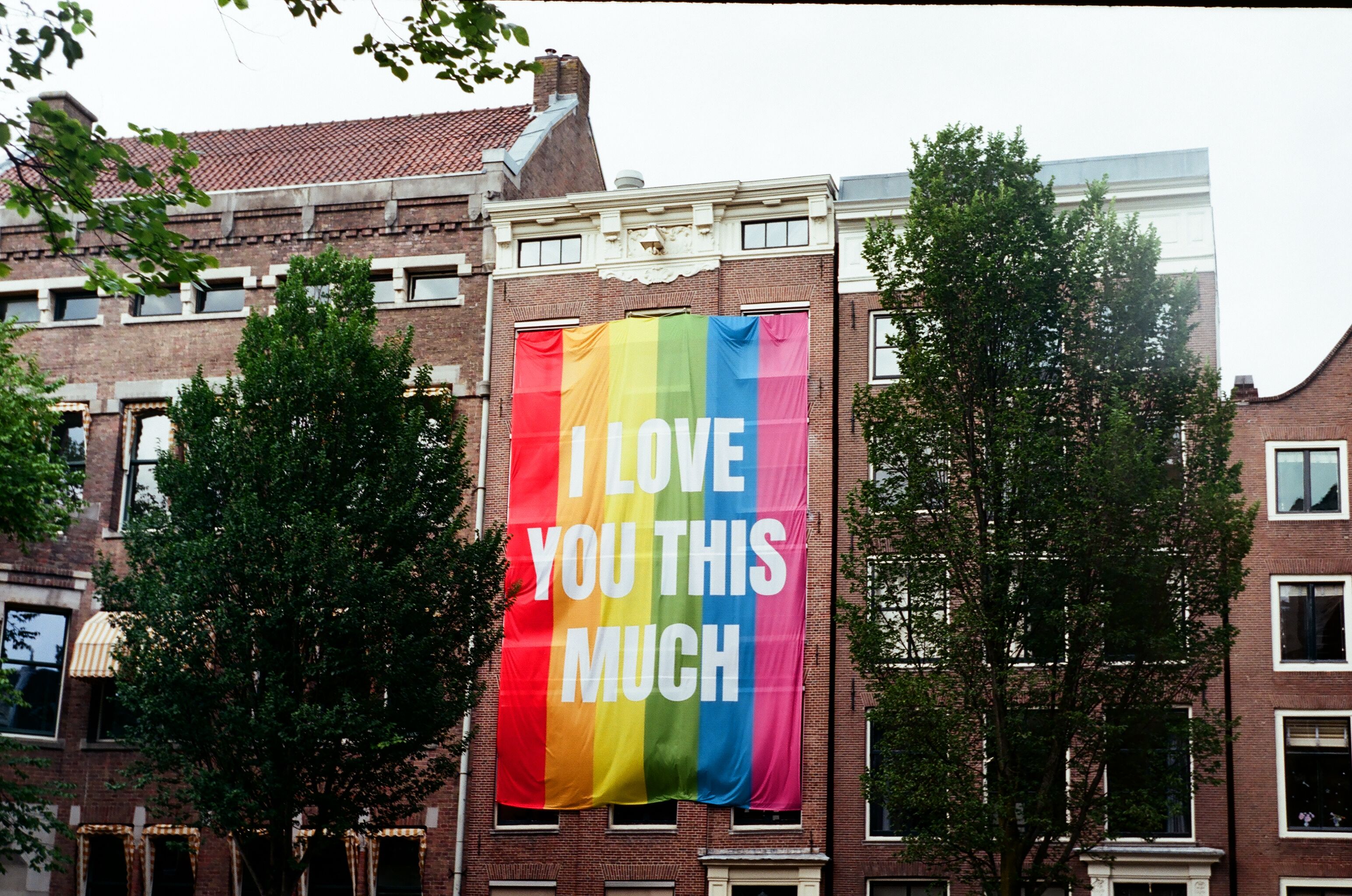 Rainbow Flag on a Building · Free Stock Photo
