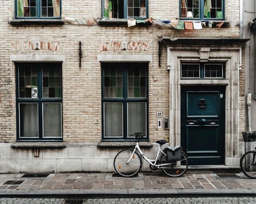 Free Historic brick facade with a bicycle in Ghent, Belgium, displaying classic European architecture. Stock Photo