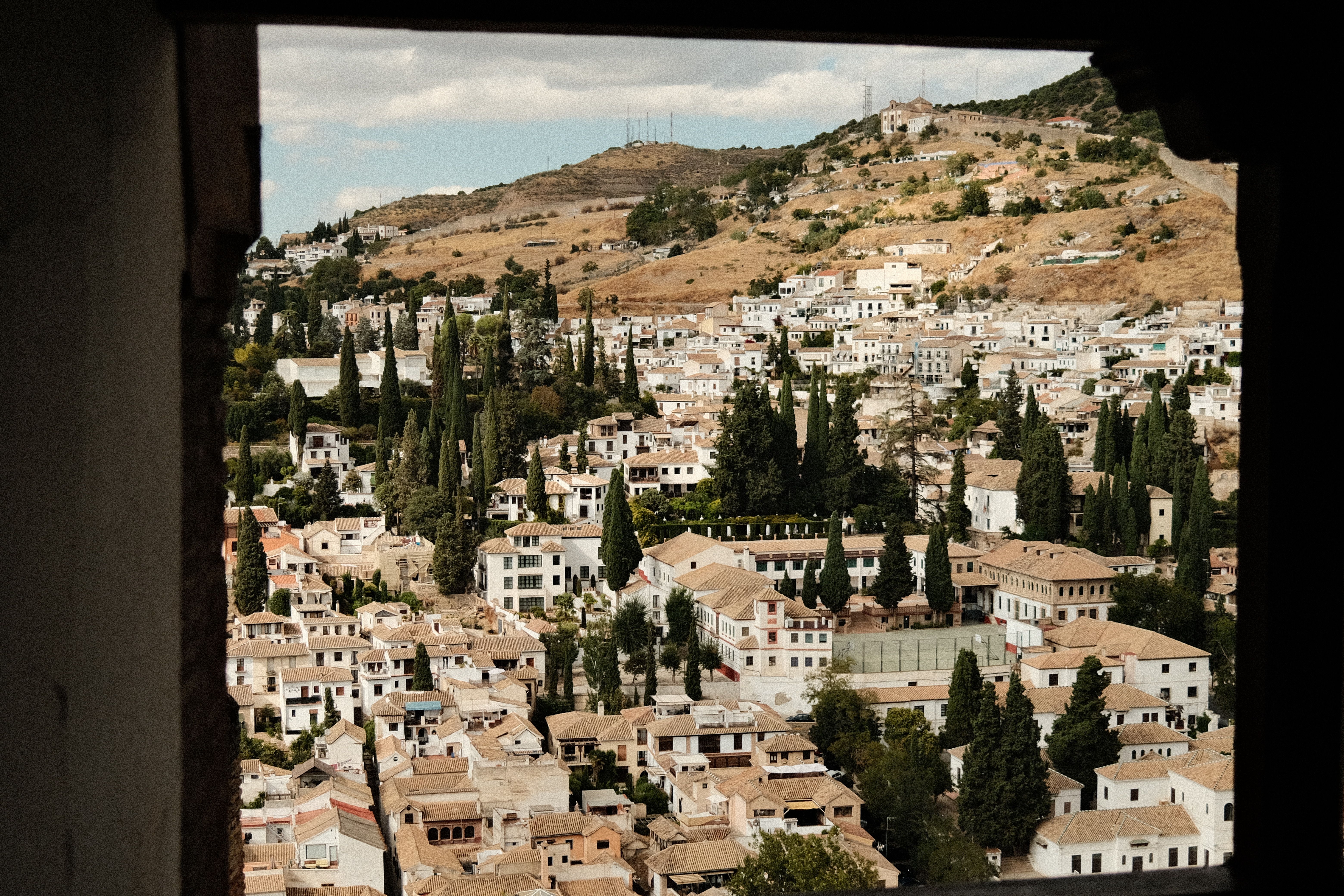 Panoramic view of the historic Albayzín neighborhood in Granada, Spain from an elevated angle.
