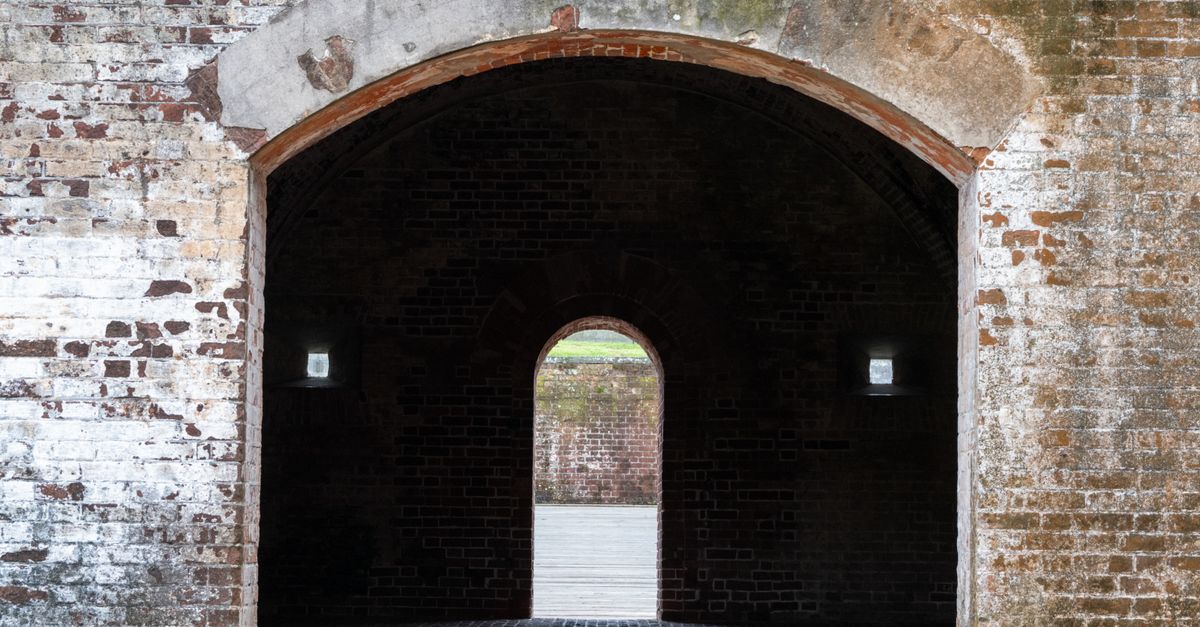 A captivating view through the brick archway of Fort Macon in Atlantic Beach, NC.