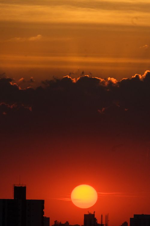 Free Stunning view of a vivid sunset over São Paulo skyline, featuring dramatic clouds and bright hues. Stock Photo