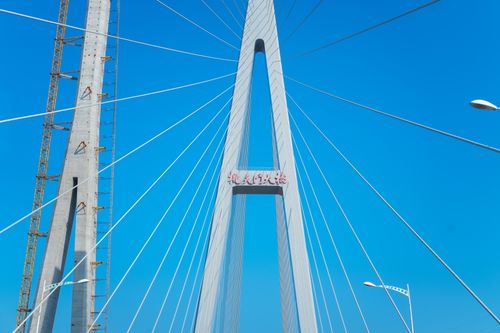 Free Stunning view of a suspension bridge with clear blue sky, showcasing engineering elegance. Stock Photo