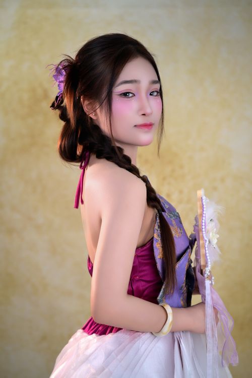 Free Stylish portrait of a woman in traditional dress, with braided hair, creating a classic look. Stock Photo