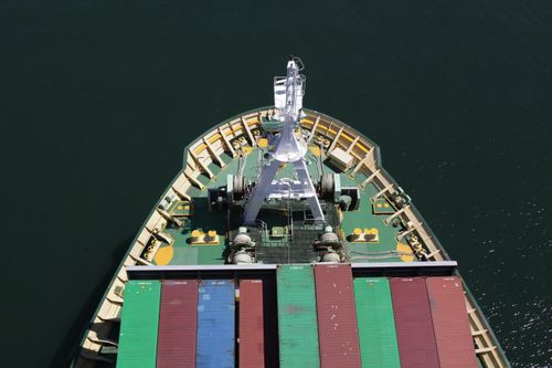 Free Top-down view of a cargo ship's bow loaded with colorful containers on the ocean. Stock Photo