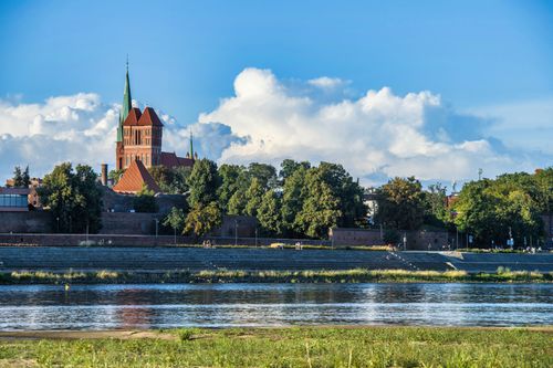 Free Beautiful view of Toruń's historic architecture and Vistula River under a clear sky. Stock Photo