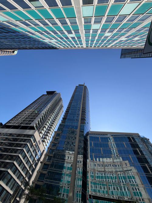 Free Dynamic upward view of modern skyscrapers in downtown Montreal under a clear blue sky. Stock Photo