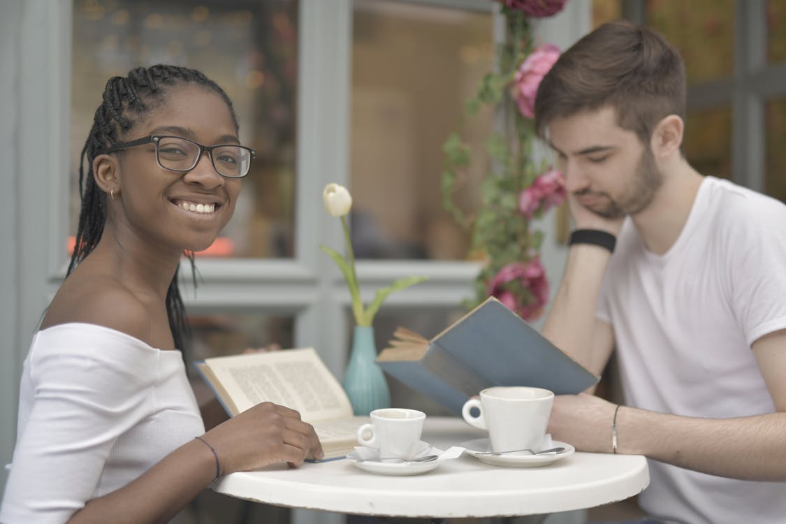 Couple Reading Books while Having Coffee