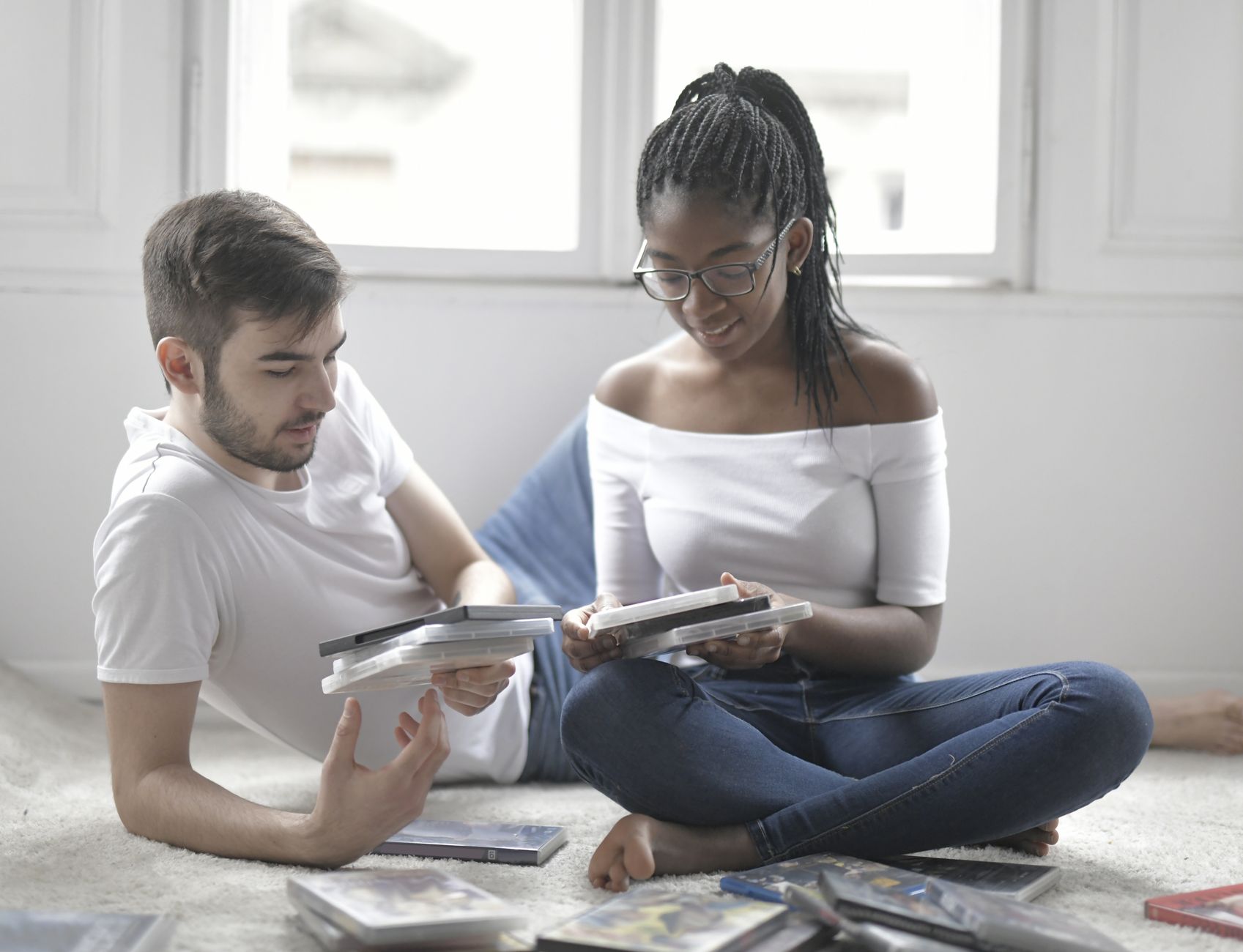 Young couple relaxing at home, choosing movies for a cozy night in.
