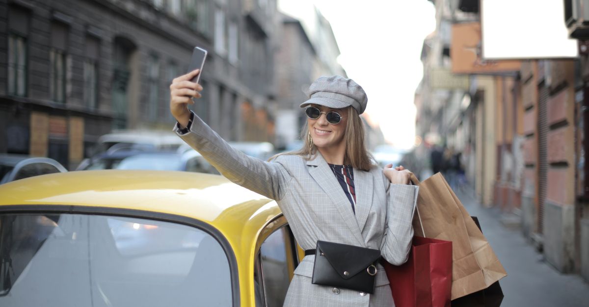 happy customer holding fast food bag in car