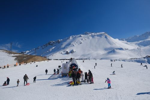 Free People skiing and snowboarding on a sunny day at Davraz Ski Center, Isparta. Stock Photo