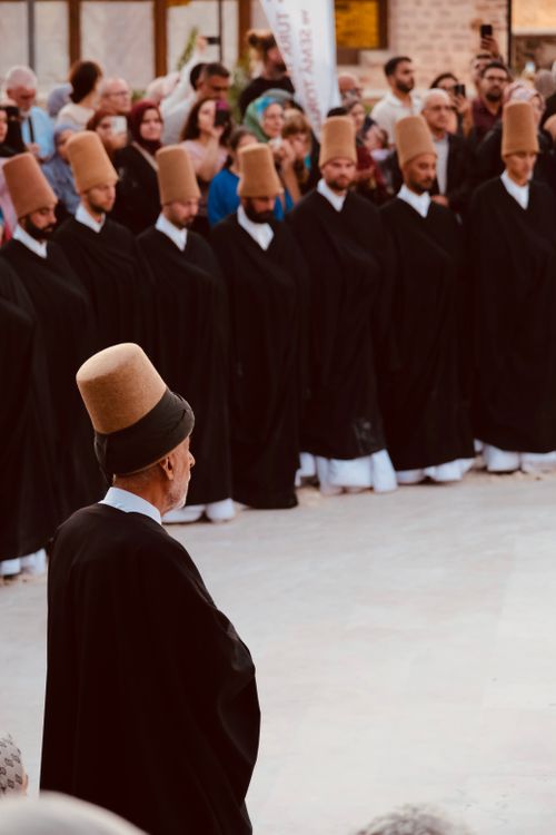 Free Sufi dervishes in traditional attire performing a spiritual ceremony in Konya, Turkey. Stock Photo