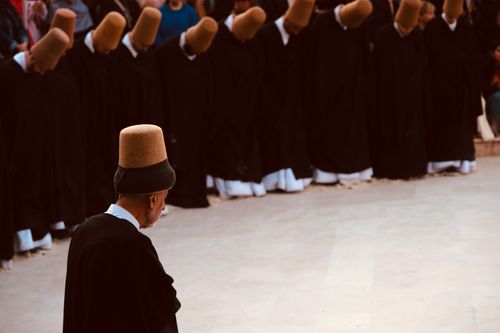 Free Sufi dervishes in traditional attire during a spiritual whirling ceremony in Konya, Turkey. Stock Photo