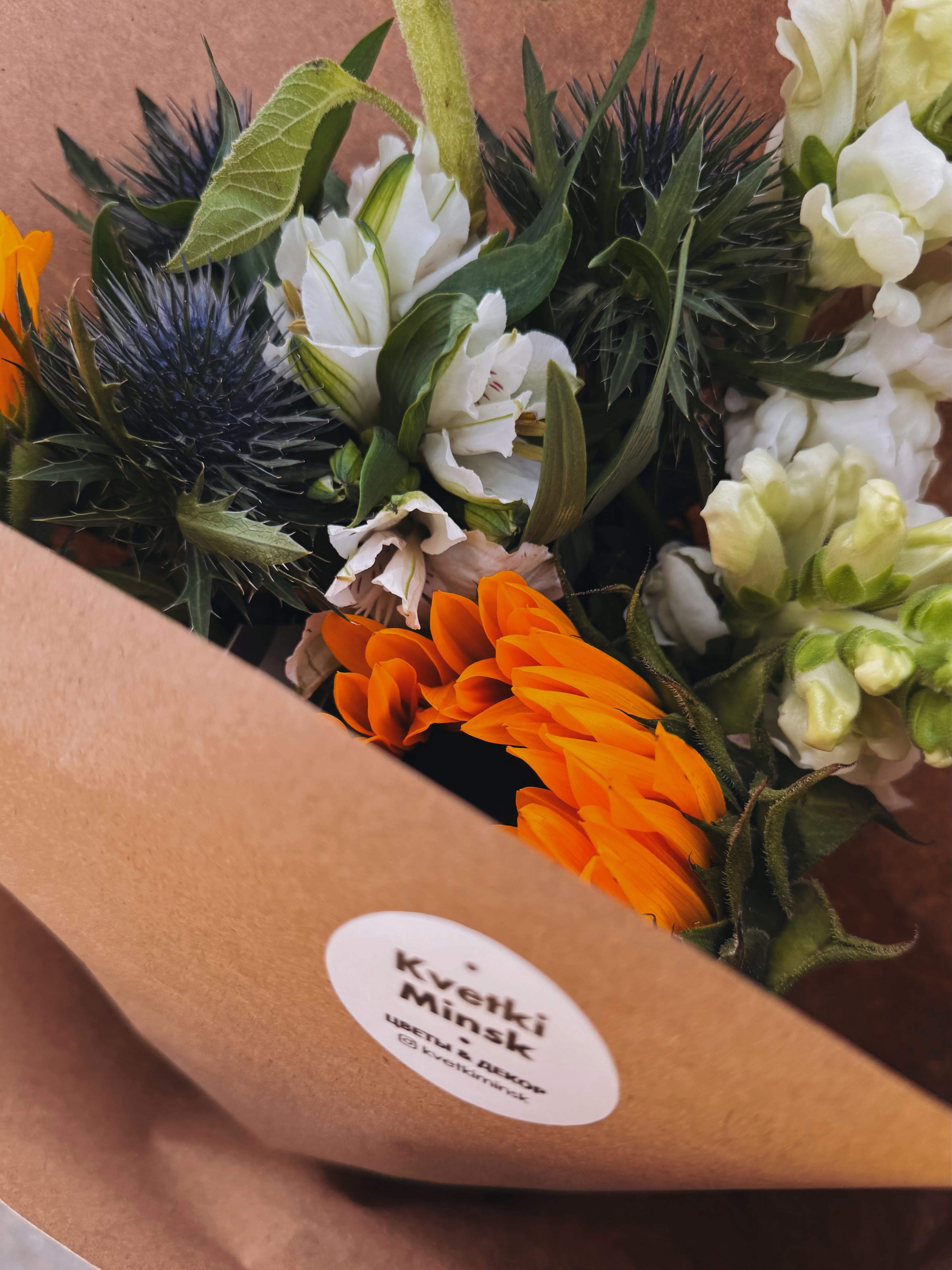 Aesthetic floral arrangement with colorful blooms wrapped in eco-friendly kraft paper.