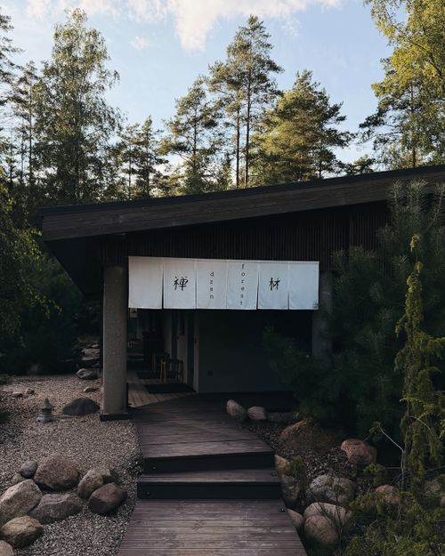Free A peaceful Japanese tea house nestled in a lush green forest. Ideal for relaxation and nature retreats. Stock Photo