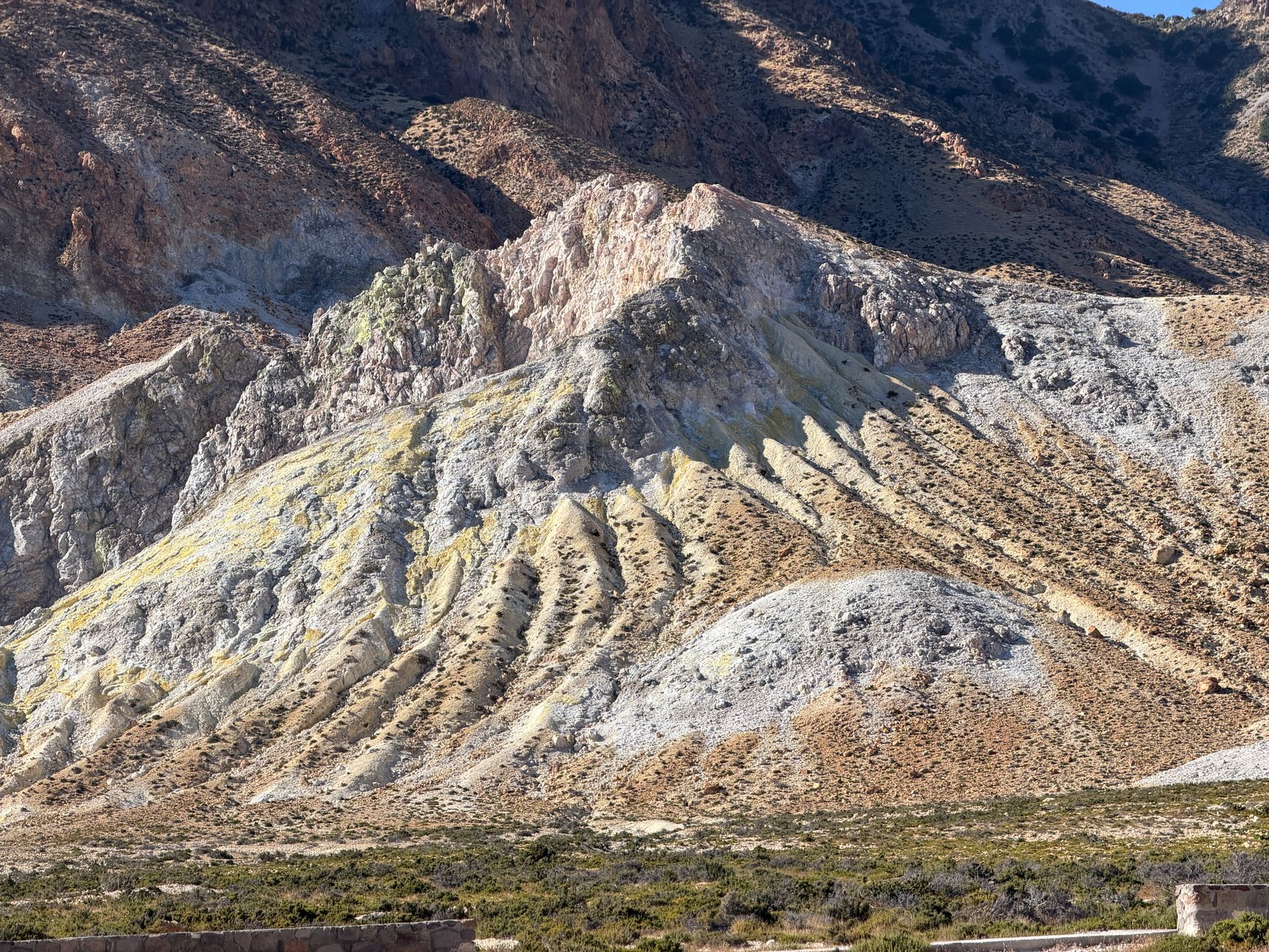 The bare volcanic rock formations of Nisyros, with the caldera beyond.