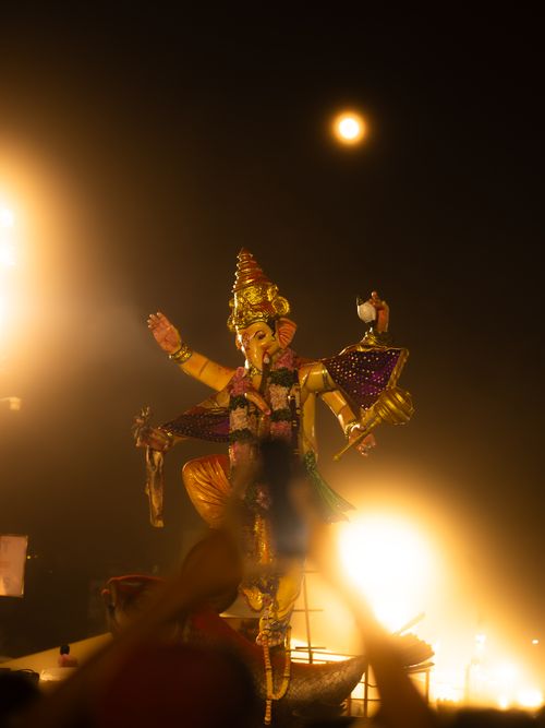 Free Illuminated statue of Lord Ganesha during Mumbai's Ganesh Chaturthi festivities at night. Stock Photo