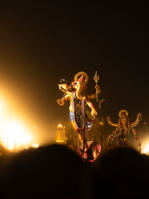 Free Illuminated Ganesh idols during a nighttime festival in Mumbai, India. Stock Photo
