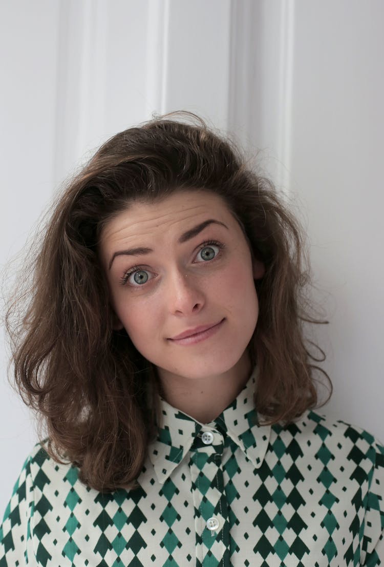 Woman With Wide Open Eyes Looking At Camera At Home