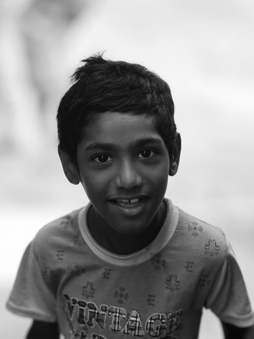 Free A joyful child smiling warmly in this black and white portrait. Stock Photo