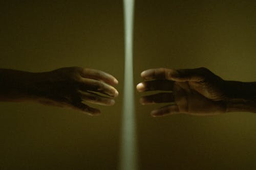 Photo of Hands Nearly Touching