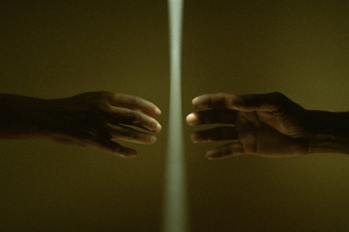Photo of Hands Nearly Touching